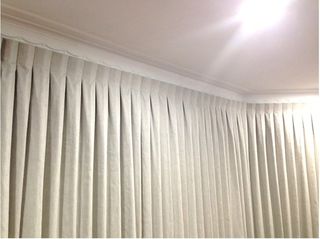 Inverted pleat curtains on bent track